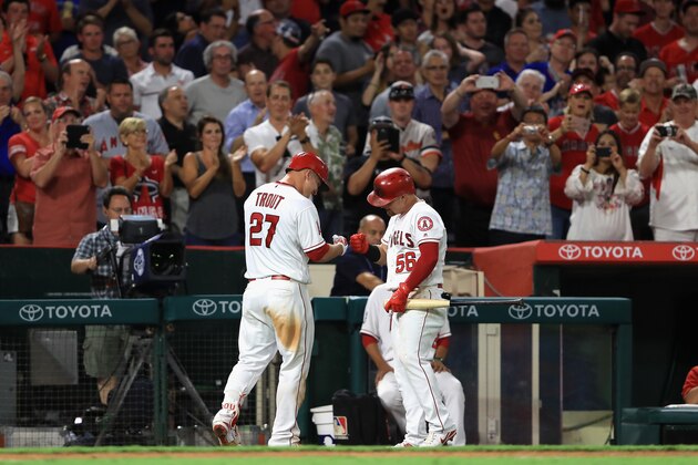 ANAHEIM, CA - AUGUST 07:  Kole Calhoun #56 congratulates  Mike Trout #27 of the Los Angeles Angels of Anaheim after he hit a solo homerun during the sixth inning of a game against the Baltimore Orioles  at Angel Stadium of Anaheim on August 7, 2017 in Anaheim, California.  (Photo by Sean M. Haffey/Getty Images)
