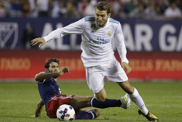 MLS All-Stars' Diego Valeri, left, tackles Real Madrid's Mateo Kovacic during the second half of the MLS All-Star Game, Wednesday, Aug. 2, 2017, in Chicago. (AP Photo/Nam Y. Huh)