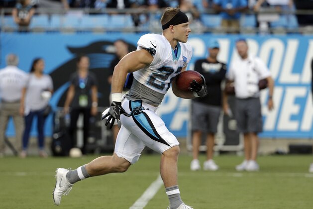 Carolina Panthers' Christian McCaffrey (22) runs with the ball during practice at the NFL football team's Fan Fest in Charlotte, N.C., Friday, Aug. 4, 2017. (AP Photo/Chuck Burton)