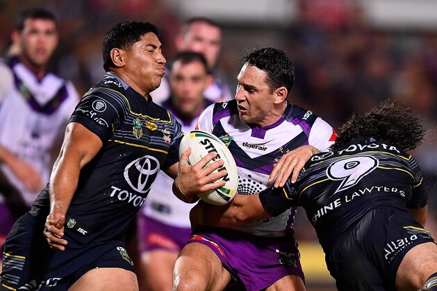 TOWNSVILLE, AUSTRALIA - AUGUST 04:  Billy Slater of the Storm is tackled by Jason Taumalolo  and Jake Granville of the Cowboys during the round 22 NRL match between the North Queensland Cowboys and the Melbourne Storm at 1300SMILES Stadium on August 4, 2017 in Townsville, Australia.  (Photo by Ian Hitchcock/Getty Images)