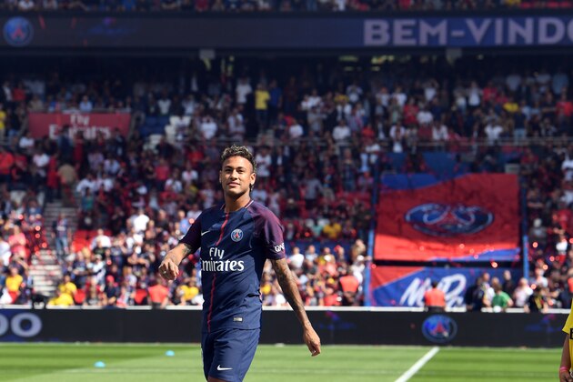 Paris Saint-Germain's Brazilian forward Neymar looks on during his presentation to the fans at the Parc des Princes stadium in Paris on August 5, 2017. 
Brazil superstar Neymar will watch from the stands as Paris Saint-Germain open their season on August 5, 2017, but the French club have already clawed back around a million euros on their world record investment. Neymar, who signed from Barcelona for a mind-boggling 222 million euros ($264 million), is presented to the PSG support prior to his new team's first game of the Ligue 1 campaign against promoted Amiens. / AFP PHOTO / ALAIN JOCARD        (Photo credit should read ALAIN JOCARD/AFP/Getty Images)