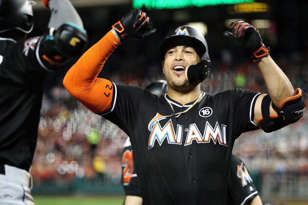 WASHINGTON, DC - AUGUST 08:  Giancarlo Stanton #27 of the Miami Marlins celebrates with Dee Gordon #9 (L) after hitting a three run home run against the Washington Nationals in the fifth inning at Nationals Park on August 8, 2017 in Washington, DC.  (Photo by Rob Carr/Getty Images)