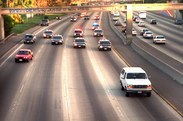 FILE - In this June 17, 1994 file photo, a white Ford Bronco, driven by Al Cowlings carrying O.J. Simpson, is trailed by Los Angeles police cars as it travels on a freeway in Los Angeles. Simpson's ex-wife, Nicole Brown Simpson, and her friend Ronald Goldman are found dead in Los Angeles. Simpson is later arrested after a widely televised freeway chase in his white Ford Bronco. (AP Photo/Joseph Villarin, File)