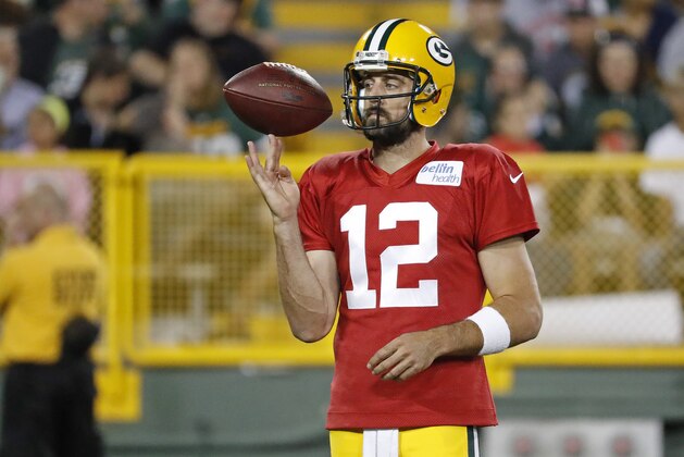 Green Bay Packers quarterback Aaron Rodgers spins a football on his finger between drills during NFL football training camp Saturday, Aug 5, 2017, in Green Bay, Wis. (AP Photo/Matt Ludtke)