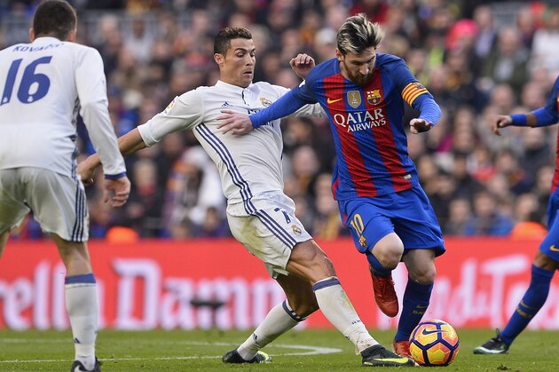Barcelona's Argentinian forward Lionel Messi (2ndR) vies with Real Madrid's Portuguese forward Cristiano Ronaldo during the Spanish league football match FC Barcelona vs Real Madrid CF at the Camp Nou stadium in Barcelona on December 3, 2016. / AFP / JOSEP LAGO        (Photo credit should read JOSEP LAGO/AFP/Getty Images)