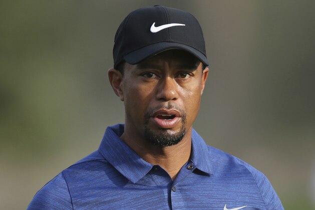 FILE - In this  Feb. 2, 2017 file photo, Tiger Woods reacts on hole 10th during the 1st round of the Dubai Desert Classic golf tournament in Dubai, United Arab Emirates.  Woods told officers during his DUI arrest last month that he had taken Xanax, as well as other prescription medications. Woods' claim was revealed in an unredacted version of the Jupiter Police Department's investigation report, obtained Friday, June 9, 2017 by The Golf Channel (AP Photo/Kamran Jebreili)