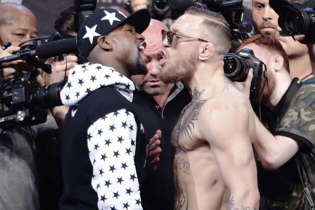 Conor McGregor, right, reacts as Floyd Mayweather Jr., left, jaw during a news conference at Barclays Center on Thursday, July 13, 2017, in New York. (AP Photo/Frank Franklin II)