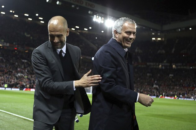 FILE - In this Wednesday, Oct. 26, 2016 file photo, Manchester City's manager Pep Guardiola, left, and Manchester United's manager Jose Mourinho smile ahead of their English League Cup soccer match at Old Trafford stadium in Manchester. There were handshakes, smiles, even an embrace, in the first two head-to-heads between Pep Guardiola and Jose Mourinho in English soccer. With the pressure and tension ramped up a notch for the third Manchester derby of the season, will the two coaching adversaries be able to retain their new-found cordiality on Thursday, April 27? (AP Photo/Dave Thompson, file)
