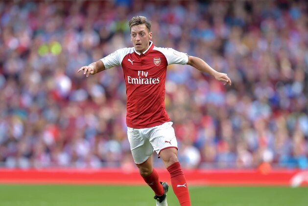 Arsenal's German midfielder Mesut Ozil controls the ball during the pre-season friendly football match between Arsenal and Sevilla at The Emirates Stadium in north London on July 30, 2017, the game is one of four matches played over two days for the Emirates Cup.  / AFP PHOTO / OLLY GREENWOOD        (Photo credit should read OLLY GREENWOOD/AFP/Getty Images)