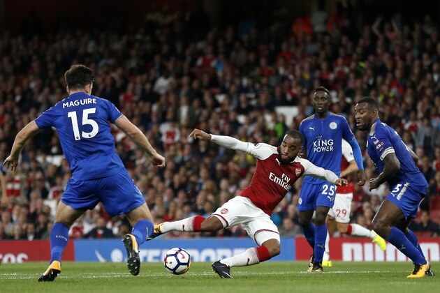 Arsenal's French striker Alexandre Lacazette (2nd L) has an unsuccessful shot as Leicester City's English defender Harry Maguire (L), Leicester City's Nigerian midfielder Wilfred Ndidi and Leicester City's English-born Jamaican defender Wes Morgan (R) look on during the English Premier League football match between Arsenal and Leicester City at the Emirates Stadium in London on August 11, 2017. / AFP PHOTO / Ian KINGTON / RESTRICTED TO EDITORIAL USE. No use with unauthorized audio, video, data, fixture lists, club/league logos or 'live' services. Online in-match use limited to 75 images, no video emulation. No use in betting, games or single club/league/player publications.  /         (Photo credit should read IAN KINGTON/AFP/Getty Images)