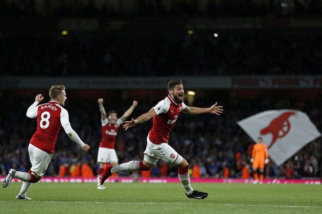 Arsenal's French striker Olivier Giroud (C) celebrates scoring Arsenal's fourth goal during the English Premier League football match between Arsenal and Leicester City at the Emirates Stadium in London on August 11, 2017. / AFP PHOTO / Ian KINGTON / RESTRICTED TO EDITORIAL USE. No use with unauthorized audio, video, data, fixture lists, club/league logos or 'live' services. Online in-match use limited to 75 images, no video emulation. No use in betting, games or single club/league/player publications.  /         (Photo credit should read IAN KINGTON/AFP/Getty Images)