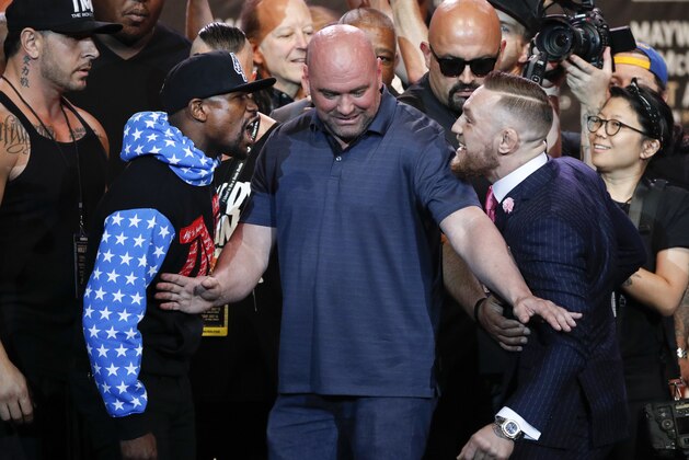 UFC president Dana White, center, intervenes as boxer Floyd Mayweather Jr., left, and mixed martial arts fighter Conor McGregor exchange words during a news conference at Staples Center Tuesday, July 11, 2017, in Los Angeles. The two are scheduled to fight in a boxing match in Las Vegas on Aug. 26. (AP Photo/Jae C. Hong) UFC president Dana White, center, intervenes as boxer Floyd Mayweather Jr., left, and mixed martial arts fighter Conor McGregor exchange words during a news conference at Staples Center Tuesday, July 11, 2017, in Los Angeles. The two are scheduled to fight in a boxing match in Las Vegas on Aug. 26. (AP Photo/Jae C. Hong)