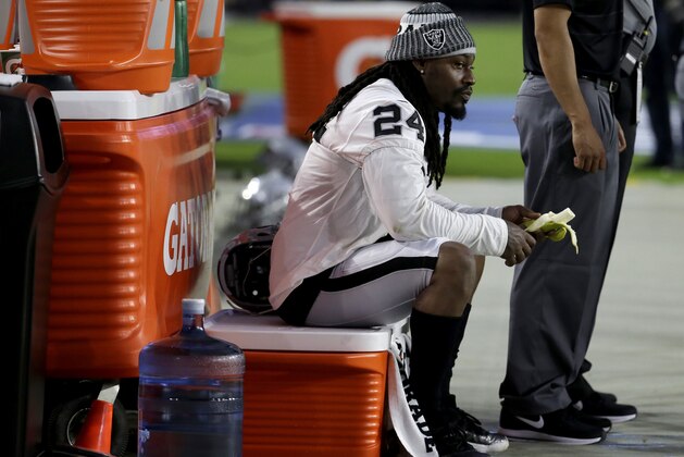 Oakland Raiders running back Marshawn Lynch (24) sits during the national anthem prior to an NFL preseason football game against the Arizona Cardinals, Saturday, Aug. 12, 2017, in Glendale, Ariz. (AP Photo/Rick Scuteri)