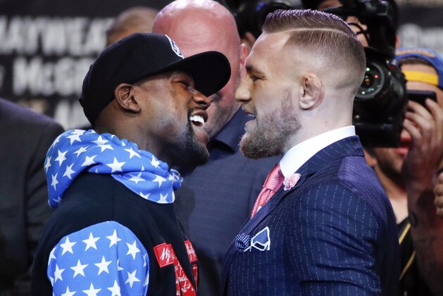 Boxer Floyd Mayweather Jr., left, and mixed martial arts fighter Conor McGregor exchange words during a news conference at Staples Center Tuesday, July 11, 2017, in Los Angeles. The two are scheduled to fight in a boxing match in Las Vegas on Aug. 26. (AP Photo/Jae C. Hong)