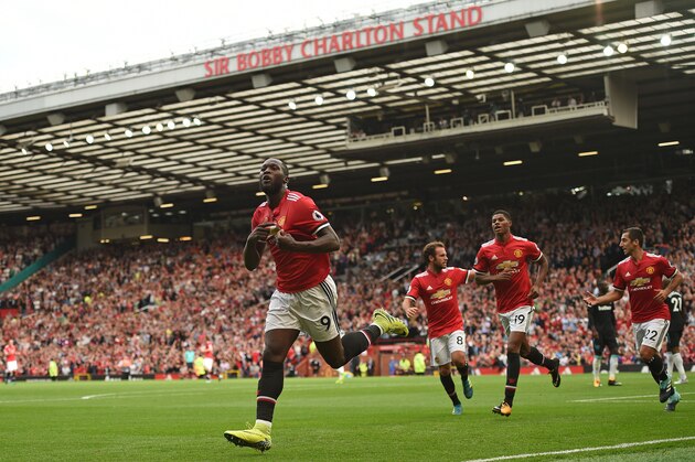 Manchester United's Belgian striker Romelu Lukaku (L) celebrates scoring the opening goal during the English Premier League football match between Manchester United and West Ham United at Old Trafford in Manchester, north west England, on August 13, 2017. / AFP PHOTO / Oli SCARFF / RESTRICTED TO EDITORIAL USE. No use with unauthorized audio, video, data, fixture lists, club/league logos or 'live' services. Online in-match use limited to 75 images, no video emulation. No use in betting, games or single club/league/player publications.  /         (Photo credit should read OLI SCARFF/AFP/Getty Images)