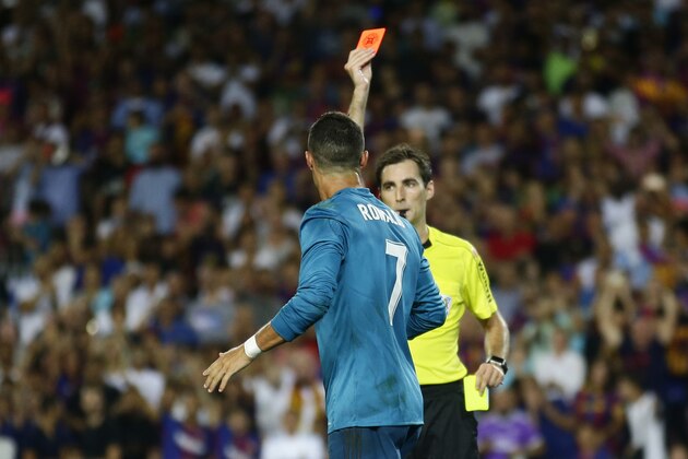 Referee Ricardo de Burgos, right, shows a red card to Real Madrid's Cristiano Ronaldo during the Spanish Supercup, first leg, soccer match between FC Barcelona and Real Madrid at the Camp Nou stadium in Barcelona, Spain, Sunday, Aug. 13, 2017. (AP Photo/Manu Fernandez)