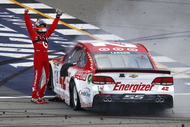 Kyle Larson celebrates winning a NASCAR Cup Series auto race in Brooklyn, Mich., Sunday, Aug. 13, 2017. (AP Photo/Paul Sancya)