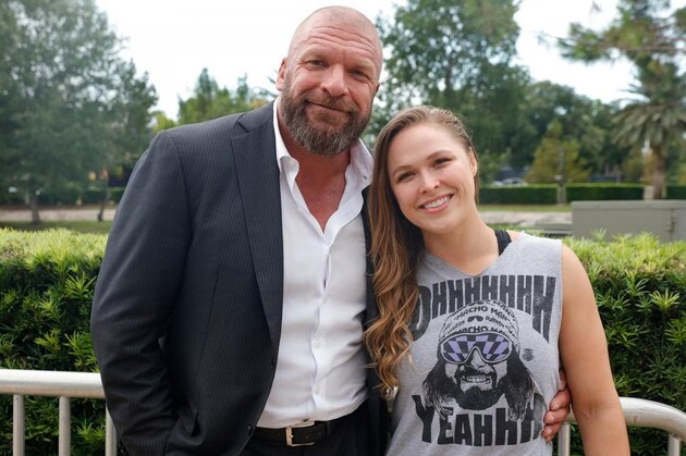 FILE - In this Feb. 22, 2014, file photo, Ronda Rousey looks around after defeating Sara McMann in a UFC 170 mixed martial arts women's bantamweight title bout in Las Vegas. Rousey is returning to the UFC on Friday, Dec. 30, 2016, after a 13-month absence, taking on Amanda Nunes for the bantamweight title. The formerly dominant champion has declined to promote her comeback fight. (AP Photo/Isaac Brekken, File)