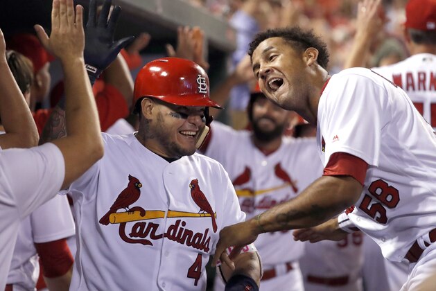 St. Louis Cardinals' Yadier Molina (4) is congratulated by Jose Martinez (58) and others after hitting a grand slam during the sixth inning of the team's baseball game against the Kansas City Royals on Wednesday, Aug. 9, 2017, in St. Louis. (AP Photo/Jeff Roberson)