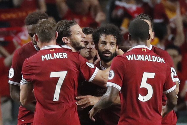 Liverpool's Mohamed Salah, center celebrates after scoring a goal during the final match against Leicester City FC at the Premier League Asia Trophy soccer tournament in Hong Kong, Saturday, July 22, 2017. (AP Photo/Kin Cheung)