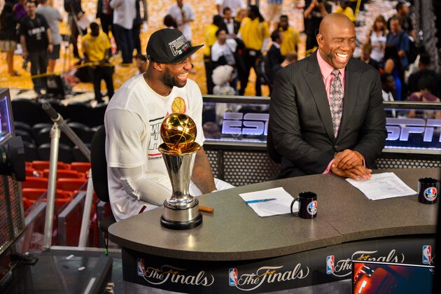 MIAMI, FL - JUNE 20: LeBron James #6 of the Miami Heat, sitting with the Bill Russell NBA Finals Most Valuable Player (MVP) trophy, is interviewed by NBA legend Magic Johnson following the Heat's victory against the San Antonio Spurs in Game Seven of the 2013 NBA Finals on June 20, 2013 at American Airlines Arena in Miami, Florida. NOTE TO USER: User expressly acknowledges and agrees that, by downloading and or using this photograph, User is consenting to the terms and conditions of the Getty Images License Agreement. Mandatory Copyright Notice: Copyright 2013 NBAE (Photo by Jesse D. Garrabrant/NBAE via Getty Images)