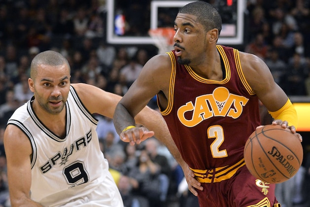 Cleveland Cavaliers guard Kyrie Irving (2) drives around San Antonio Spurs guard Tony Parker during the first half of an NBA basketball game Thursday, Jan. 14, 2016, in San Antonio. San Antonio won 99-95. (AP Photo/Darren Abate)