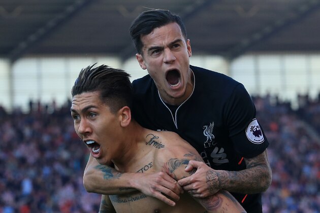 Liverpool's Brazilian midfielder Roberto Firmino (L) celebrates scoring his team's second goal with Liverpool's Brazilian midfielder Philippe Coutinho during the English Premier League football match between Stoke City and Liverpool at the Bet365 Stadium in Stoke-on-Trent, central England on April 8, 2017. / AFP PHOTO / Lindsey PARNABY / RESTRICTED TO EDITORIAL USE. No use with unauthorized audio, video, data, fixture lists, club/league logos or 'live' services. Online in-match use limited to 75 images, no video emulation. No use in betting, games or single club/league/player publications.  /         (Photo credit should read LINDSEY PARNABY/AFP/Getty Images)