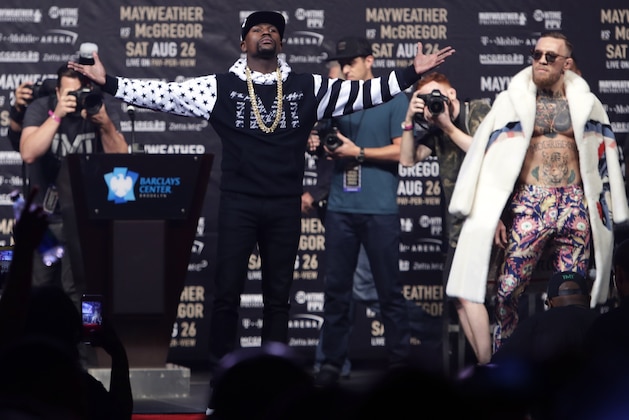 Floyd Mayweather Jr., front left, poses as Conor McGregor, right, watches during a news conference at Barclays Center on Thursday, July 13, 2017, in New York, for their junior middleweight boxing bout next month. (AP Photo/Frank Franklin II)