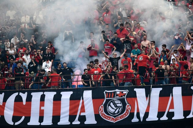 AC Milan's supporters celebrate a goal during the Italian Serie A football match Inter Milan vs AC Milan at 'San Siro' Stadium in Milan on April 15, 2017.   / AFP PHOTO / MIGUEL MEDINA        (Photo credit should read MIGUEL MEDINA/AFP/Getty Images)