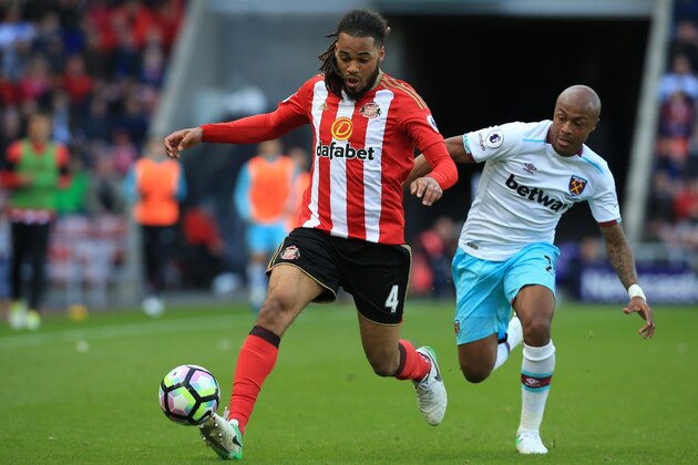 Sunderland's Dutch defender Jason Denayer (L) vies with West Ham United's French-born Ghanaian midfielder Andre Ayew during the English Premier League football match between Sunderland and West Ham United at the Stadium of Light in Sunderland, north-east England on April 15, 2017. / AFP PHOTO / Lindsey PARNABY / RESTRICTED TO EDITORIAL USE. No use with unauthorized audio, video, data, fixture lists, club/league logos or 'live' services. Online in-match use limited to 75 images, no video emulation. No use in betting, games or single club/league/player publications.  /         (Photo credit should read LINDSEY PARNABY/AFP/Getty Images)