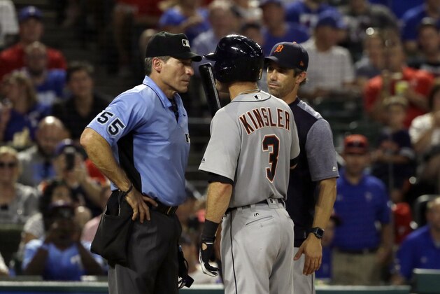 Home plate umpire Angel Hernandez, listens to Detroit Tigers' Ian Kinsler (3) as manager Brad Ausmus stands by in the fifth inning of a baseball game, Monday, Aug. 14, 2017, in Arlington, Texas. Kinsler and Ausmus were ejected by Hernandez during the argument. (AP Photo/Tony Gutierrez)