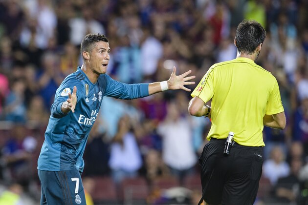 BARCELONA, SPAIN - AUGUST 13: Cristiano Ronaldo of Real Madrid (L) gestures after gets a red card from Fifa Referee Ricardo de Burgos Bergoetxea (R) during the Supercopa de Espana Final 1st Leg match between FC Barcelona and Real Madrid at Camp Nou on August 13, 2017 in Barcelona, Spain. (Photo by Marcio Rodrigo Machado/Power Sport Images/Getty Images,)