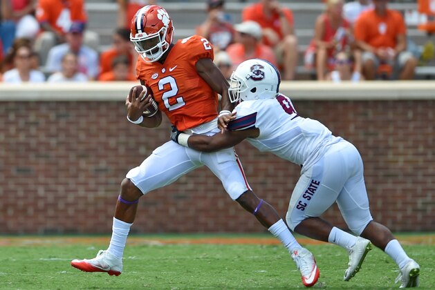 Clemson quarterback Kelly Byrant rushes out of the pocket while defended by South Carolina State's Kendric Gathers during the second half of an NCAA college football game Saturday, Sept. 17, 2016,  in Clemson,  S.C. Clemson won 59-0. (AP Photo/Richard Shiro)