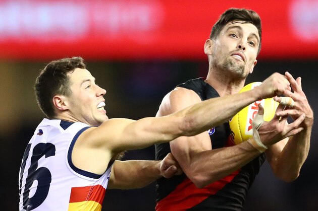 MELBOURNE, VICTORIA - AUGUST 12:  David Myers of the Bombers and Luke Brown of the Crows compete for the ball during the round 21 AFL match between the Essendon Bombers and the Adelaide Crows at Etihad Stadium on August 12, 2017 in Melbourne, Australia.  (Photo by Scott Barbour/AFL Media/Getty Images)