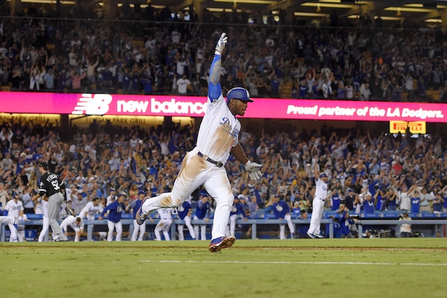 Los Angeles Dodgers' Yasiel Puig celebrates as he runs to first after hitting a two-run double during the ninth inning to give the Dodgers a 5-4 win in a baseball game against the Chicago White Sox, Wednesday, Aug. 16, 2017, in Los Angeles. (AP Photo/Mark J. Terrill)