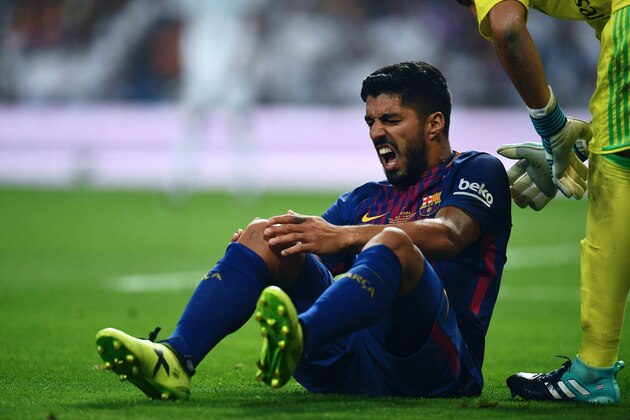 Barcelona's Uruguayan forward Luis Suarez grimaces as he sits on the ground during the second leg of the Spanish Supercup football match Real Madrid vs FC Barcelona at the Santiago Bernabeu stadium in Madrid, on August 16, 2017. / AFP PHOTO / GABRIEL BOUYS        (Photo credit should read GABRIEL BOUYS/AFP/Getty Images)