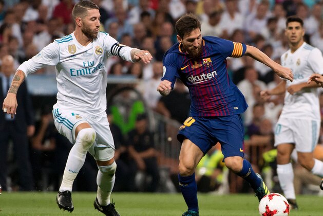 Real Madrid's defender Sergio Ramos (L) vies with Barcelona's Argentinian forward Lionel Messi during the second leg of the Spanish Supercup football match Real Madrid vs FC Barcelona at the Santiago Bernabeu stadium in Madrid, on August 16, 2017. / AFP PHOTO / CURTO DE LA TORRE        (Photo credit should read CURTO DE LA TORRE/AFP/Getty Images)