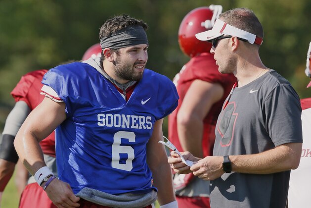 Oklahoma head coach Lincoln Riley, right, talks with quarterback Baker Mayfield, left, during an NCAA college football practice in Norman, Okla., Thursday, Aug. 3, 2017. (AP Photo/Sue Ogrocki)