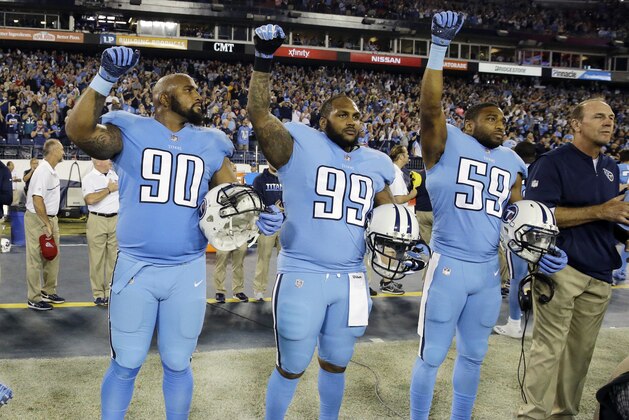 Tennessee Titans defensive lineman DaQuan Jones (90), defensive tackle Jurrell Casey (99) and inside linebacker Wesley Woodyard (59) raise their fists after the national anthem before an NFL football game between the Titans and the Jacksonville Jaguars Thursday, Oct. 27, 2016, in Nashville, Tenn. (AP Photo/James Kenney)