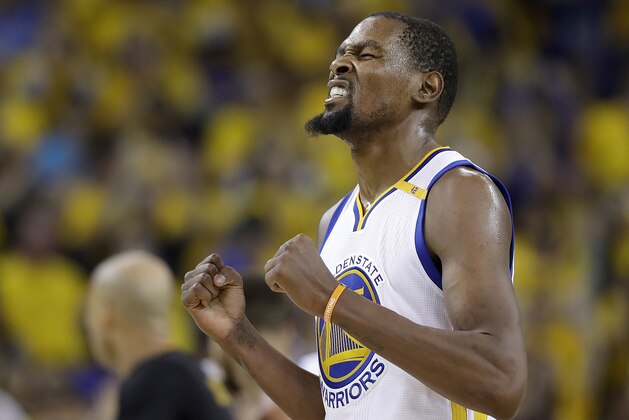 FILE - In this June 12, 2017, file photo, Golden State Warriors forward Kevin Durant reacts after scoring against the Cleveland Cavaliers during the second half of Game 5 of basketball's NBA Finals in Oakland, Calif. The 2017 NBA Champion Golden State Warriors  signed Stephen Curry, Kevin Durant, Andre Iguodala, Shaun Livingston, Zaza Pachulia and David West to contracts, the team announced Tuesday, July 25, 2017. (AP Photo/Marcio Jose Sanchez, File)