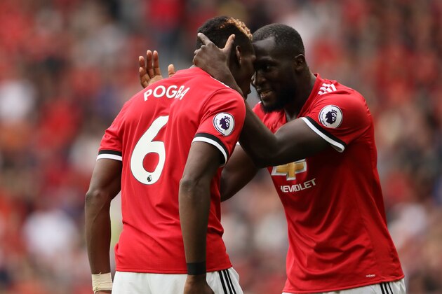 MANCHESTER, ENGLAND - AUGUST 13: Paul Pogba of Manchester United celebrates after scoring a goal to make it 4-0 with Romelu Lukaku during the Premier League match between Manchester United and West Ham United at Old Trafford on August 13, 2017 in Manchester, England. (Photo by Matthew Ashton - AMA/Getty Images)