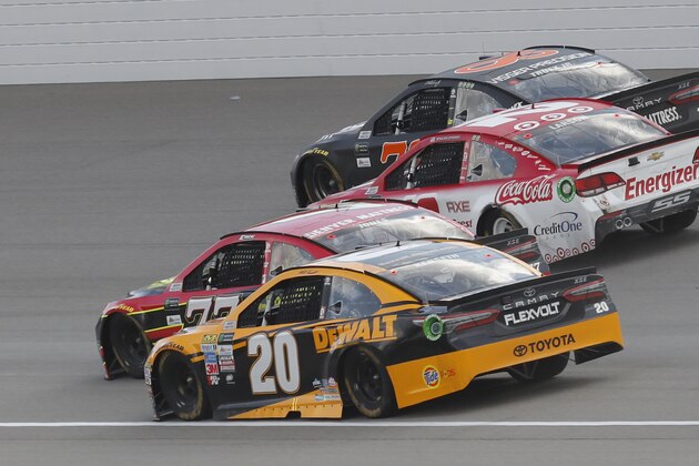 Matt Kenseth (20); Erik Jones (77); Kyle Larson (42) and Martin Truex Jr. (78) head into turn one on the last restart of the NASCAR Cup Series auto race in Brooklyn, Mich., Sunday, Aug. 13, 2017. Larson won the race. (AP Photo/Paul Sancya)