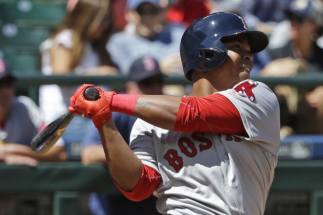 Boston Red Sox's Rafael Devers follows through after hitting a solo home run, his first major-league hit, in the third inning of a baseball game against the Seattle Mariners, Wednesday, July 26, 2017, in Seattle. (AP Photo/Ted S. Warren)