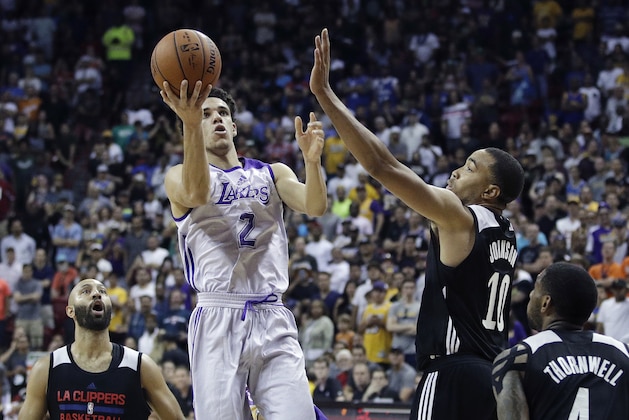 Los Angeles Lakers' Lonzo Ball shoots over Los Angeles Clippers' Brice Johnson (10) during overtime of an NBA summer league basketball game, Friday, July 7, 2017, in Las Vegas. (AP Photo/John Locher)