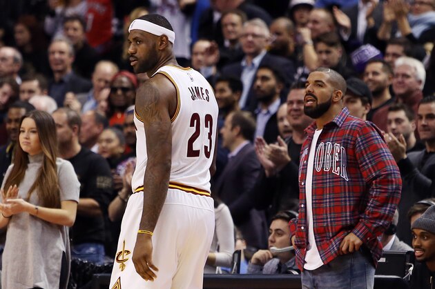 TORONTO, ON - NOVEMBER 25:  Singer Drake talks to LeBron James #23 of the Cleveland Cavaliers during an NBA game between the Cleveland Cavaliers and the Toronto Raptors at the Air Canada Centre on November 25, 2015 in Toronto, Ontario, Canada.  NOTE TO USER: User expressly acknowledges and agrees that, by downloading and or using this photograph, User is consenting to the terms and conditions of the Getty Images License Agreement.  (Photo by Vaughn Ridley/Getty Images)