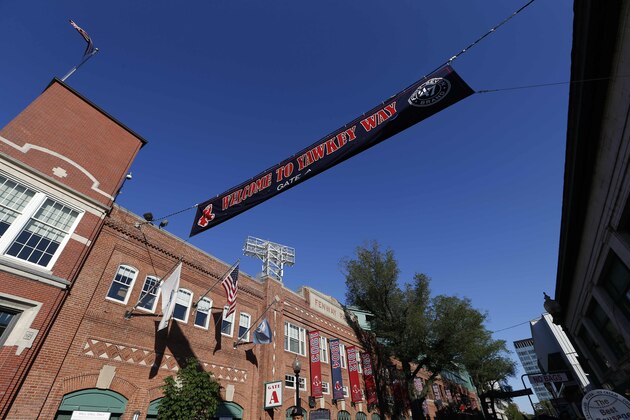 A banner hangs over Yawkey Way outside Fenway Park in Boston before a baseball game between the Boston Red Sox and the Tampa Bay Rays, Saturday, May 31, 2014. (AP Photo/Michael Dwyer)