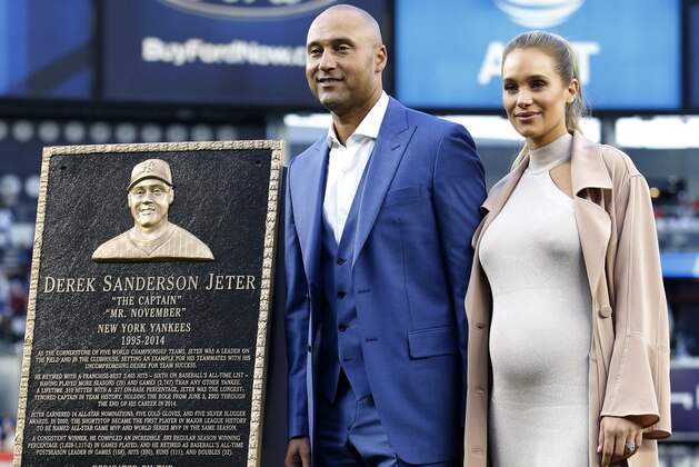 Retired New York Yankees shortstop Derek Jeter and his wife Hannah Jeter stand beside his Monument Psrtk plaque during an on-field, pregame ceremony retiring Jeter's number 2 at Yankee Stadium in New York, Sunday, May 14, 2017. (AP Photo/Kathy Willens, Pool)