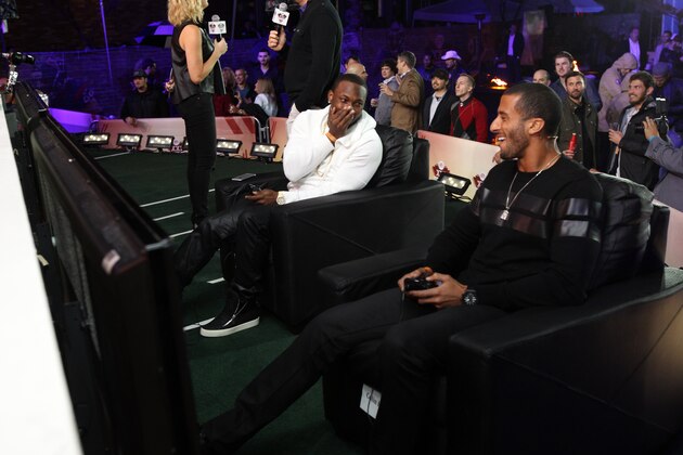 Colin Kaepernick and LeSean McCoy play in the EA SPORTS Madden Bowl 2015 Thursday, Jan., 29, 2015, in Phoenix. (Photo by Donald Traill/Invision for EA SPORTS/AP Images)