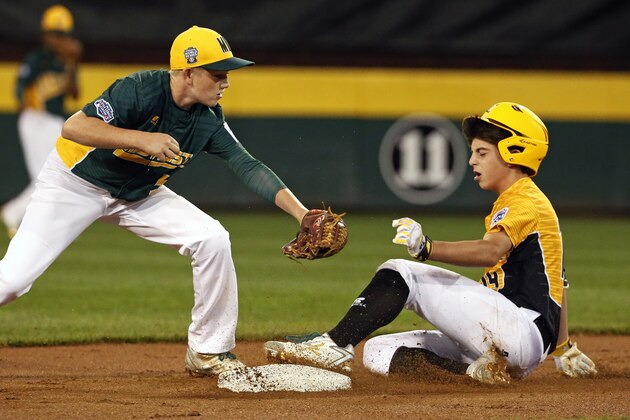 Greenville, N.C.'s Thomas Barrett, right, slides into second with a double ahead of the tag by Sioux Falls, S.D., second baseman Beau Giblin in the first inning of a baseball game in United States pool play at the Little League World Series tournament in South Williamsport, Pa., Friday, Aug. 18, 2017. (AP Photo/Gene J. Puskar)