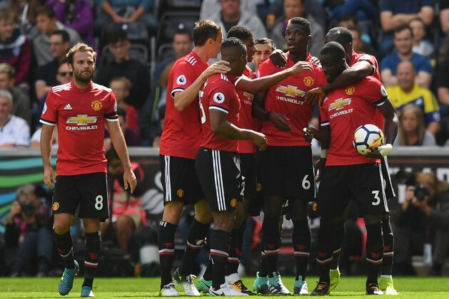 SWANSEA, WALES - AUGUST 19:  Eric Bailly of Manchester United celebrates scoring his sides first goal with his Manchester Untited team mates during the Premier League match between Swansea City and Manchester United at Liberty Stadium on August 19, 2017 in Swansea, Wales.  (Photo by Dan Mullan/Getty Images)